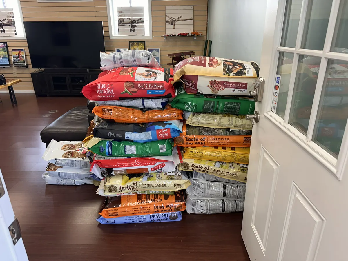 Bags of donated pet food stacked high, ready to fly to Molokaʻi
